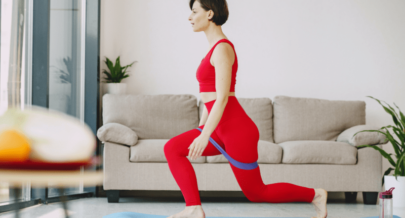 Girl doing lunges with booty band- W can do different lunges exercises like side lunges, walking lunges, curtsey lunges, reverse lunges, dumbbell lunges, lateral lunges, weighted lunges, jumping lunges, barbell lunges as hip band workout-CCB