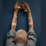 Hair growth after chemo, health and hair loss: Photo by SHVETS production: https://www.pexels.com/photo/mindful-woman-with-blooming-flowers-and-raised-arms-6984597/
