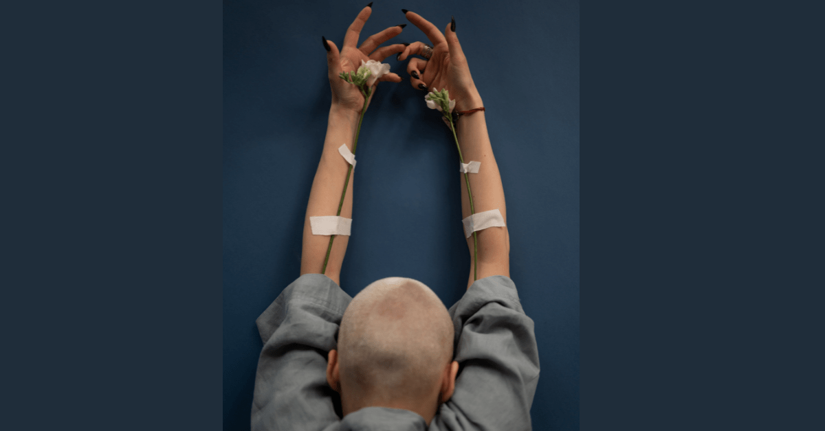 Hair growth after chemo, health and hair loss: Photo by SHVETS production: https://www.pexels.com/photo/mindful-woman-with-blooming-flowers-and-raised-arms-6984597/